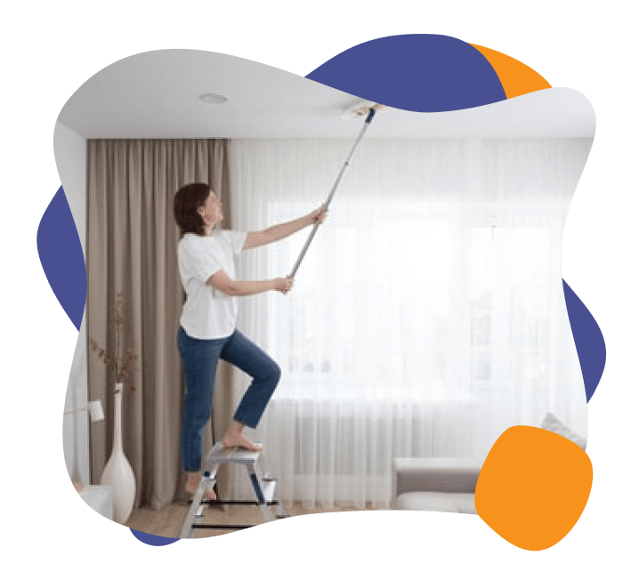 A lady cleaning ceilings in her home.
